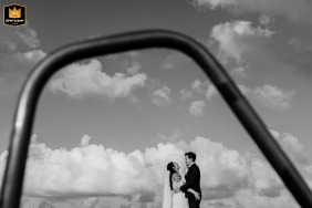 Tulum, Mexico, provides the tropical setting for a creative portrait of the bride and groom captured through the distinctive shape of a pool arch.